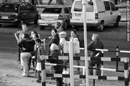 Pedestrians waiting for the train crossing -  - MORE IMAGES. Photo #45209