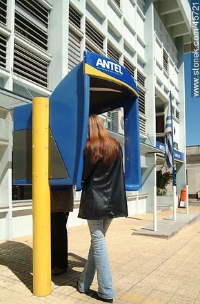Young woman talking on phone in an Antel cab - Department of Canelones - URUGUAY. Photo #45721