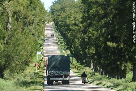 Route 7. Loaded truck overtaking a motorcyclist. - Department of Canelones - URUGUAY. Photo #45690