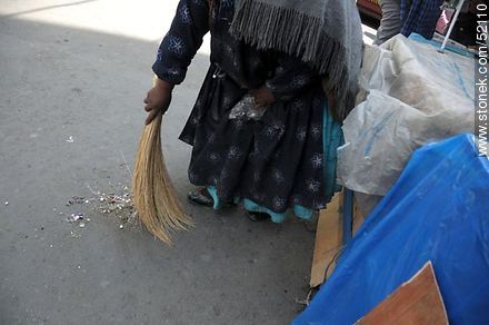 Chola cleaning the street with a hand broom in front of his stall - Bolivia - Others in SOUTH AMERICA. Photo #52110