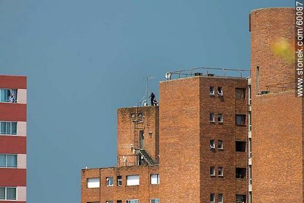 Workers on the roof of a building -  - MORE IMAGES. Photo #60087