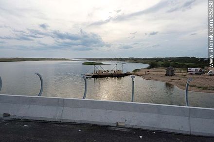 final stage of the construction of the bridge over the Garzon lagoon. In the background, the raft used for transporting vehicles - Department of Rocha - URUGUAY. Photo #65268