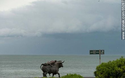Sculpture of a bull and a woman in approaching storm - Punta del Este and its near resorts - URUGUAY. Photo #65287