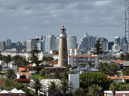 Aerial view of the lighthouse between the surrounding buildings and the distant ones - Punta del Este and its near resorts - URUGUAY. Photo #77231
