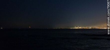 The new moon about to set in the sea in front of the port of Montevideo - Department of Montevideo - URUGUAY. Photo #79087