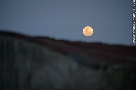 Full moon peeking out from behind a roof. -  - MORE IMAGES. Photo #81724