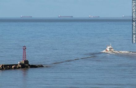 Puerto Buceo. Cargo ships on the horizon waiting to enter port. Boat to carry pilots to ships. - Department of Montevideo - URUGUAY. Photo #45791