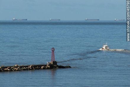 Puerto Buceo. Cargo ships on the horizon waiting to enter port. Boat to carry pilots to ships. - Department of Montevideo - URUGUAY. Photo #45790