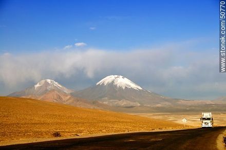 Truck on Route 11 from Bolivia. Pomerape and Parinacota volcanoes in the mountains of Nevados de Payachatas - Chile - Others in SOUTH AMERICA. Photo #50770