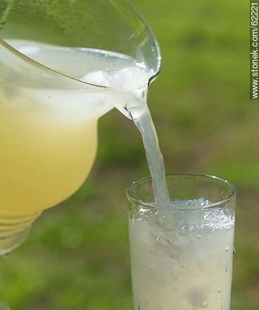 Lemonade with ice in a glass jar being served in a glass -  - MORE IMAGES. Photo #62221