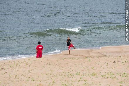 Lifeguards having fun in a stormy day and empty beach - Department of Maldonado - URUGUAY. Photo #65983