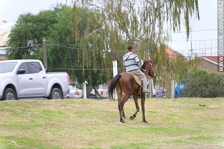 Rider on horseback near route 5 - Department of Canelones - URUGUAY. Photo #69882