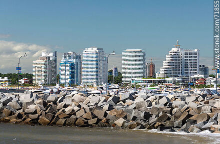 Blocks of the harbor breakwater with buildings on Williman Creek in the background. - Punta del Este and its near resorts - URUGUAY. Photo #71855