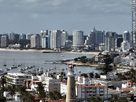 Aerial view of the lighthouse between the surrounding buildings and the distant ones - Punta del Este and its near resorts - URUGUAY. Photo #77234