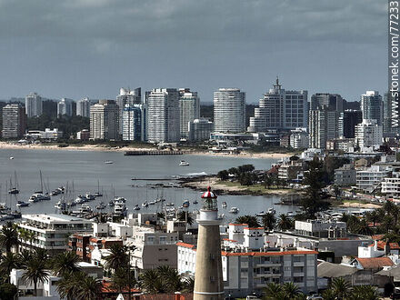Aerial view of the lighthouse between the surrounding buildings and the distant ones - Punta del Este and its near resorts - URUGUAY. Photo #77233