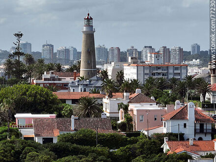Aerial view of the lighthouse between the surrounding buildings and the distant ones - Punta del Este and its near resorts - URUGUAY. Photo #77230
