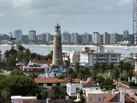 Aerial view of the lighthouse between the surrounding buildings and the distant ones - Punta del Este and its near resorts - URUGUAY. Photo #77229