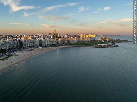 Aerial view of the Pocitos promenade and beach with the last rays of sunlight over the buildings - Department of Montevideo - URUGUAY. Photo #78642