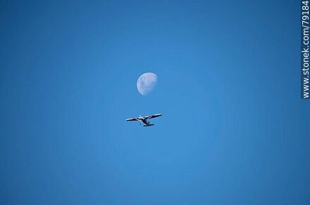 Light aircraft accompanying the moon in the sky -  - MORE IMAGES. Photo #79184