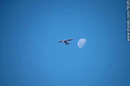 Light aircraft accompanying the moon in the sky -  - MORE IMAGES. Photo #79185