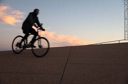 Cyclist on the promenade at sunset -  - MORE IMAGES. Photo #79145