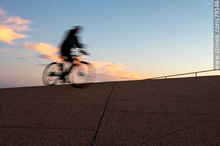 Cyclist on the promenade at sunset -  - MORE IMAGES. Photo #79146