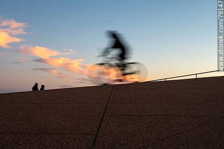 Cyclist on the promenade at sunset -  - MORE IMAGES. Photo #79147
