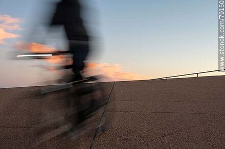 Cyclist on the promenade at sunset -  - MORE IMAGES. Photo #79150