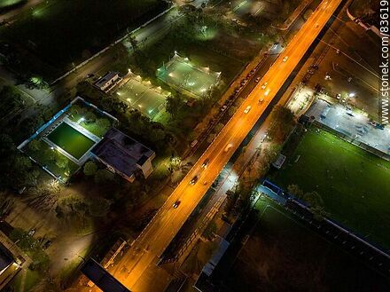Vista aérea de la Av. Cnel. Carlos Lecueder al anochecer y sus canchas iluminadas - Departamento de Artigas - URUGUAY. Foto No. 83619