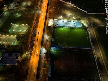 Vista aérea de la Av. Cnel. Carlos Lecueder al anochecer y sus canchas iluminadas - Departamento de Artigas - URUGUAY. Foto No. 83618