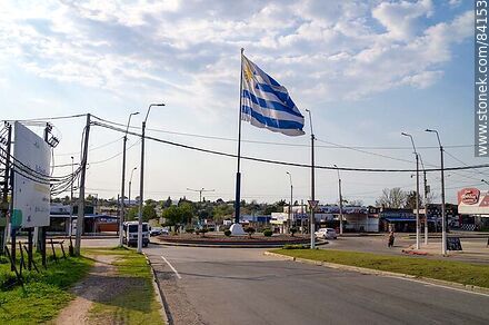 Bandera uruguaya flameando en el cruce de las avenidas Artigas, Salto y Ferreira Aldunate - Departamento de Paysandú - URUGUAY. Foto No. 84153