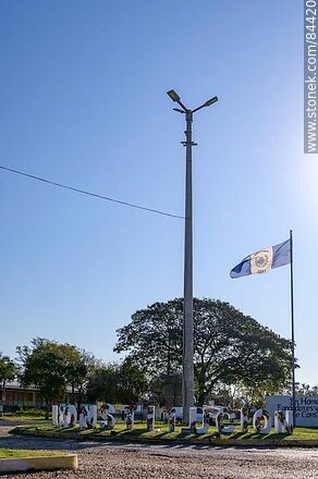 Sign and flag of Villa Constitución at the entrance to the village - Department of Salto - URUGUAY. Photo #84420