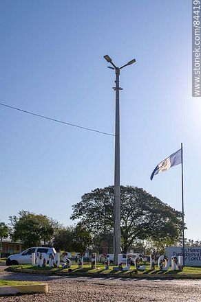 Sign and flag of Villa Constitución at the entrance to the village - Department of Salto - URUGUAY. Photo #84419