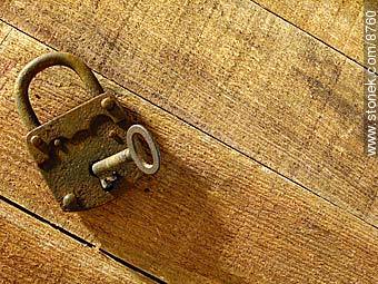Old rusty padlock and key, on a table.  -  - MORE IMAGES. Photo #8760