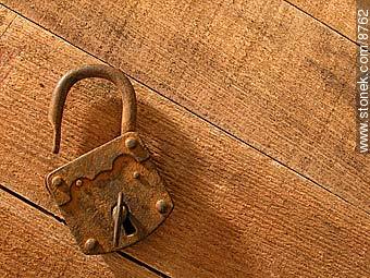 Old rusty padlock and key, on a table.  -  - MORE IMAGES. Photo #8762
