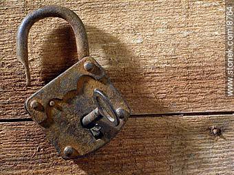 Old rusty padlock and key, on a table.  -  - MORE IMAGES. Photo #8764